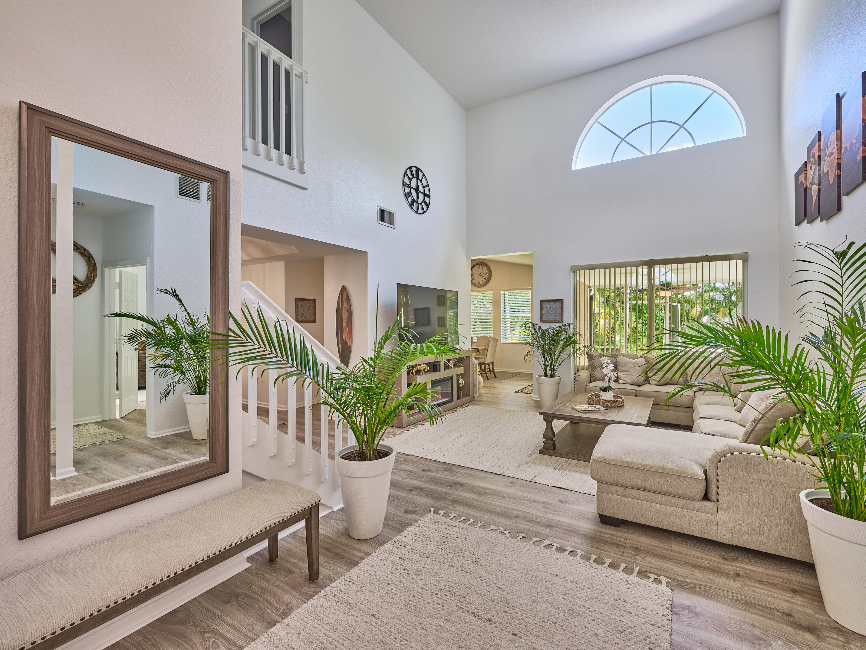 a living room with furniture and a potted plant