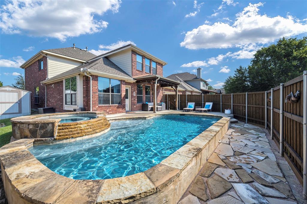 a view of a house with swimming pool and sitting area