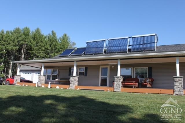 a view of a house with a backyard porch and sitting area