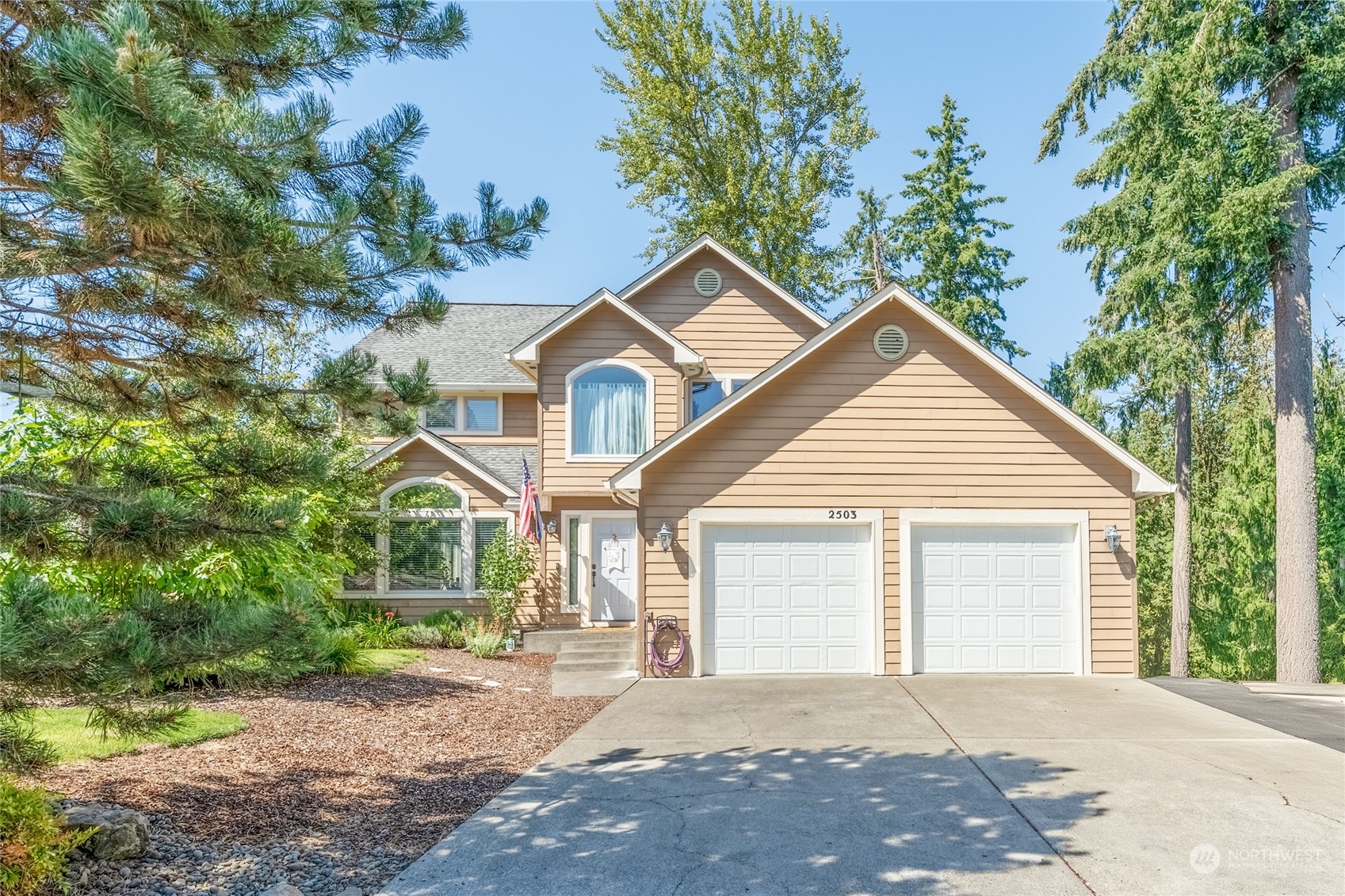 a front view of a house with a yard and garage