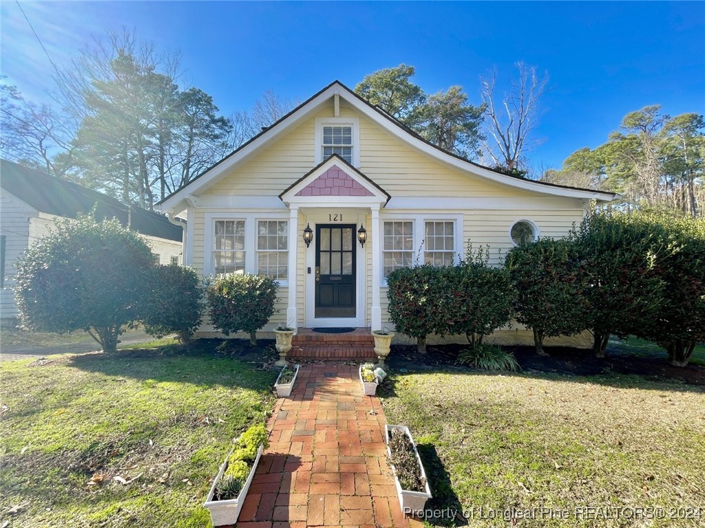 a front view of a house with garden