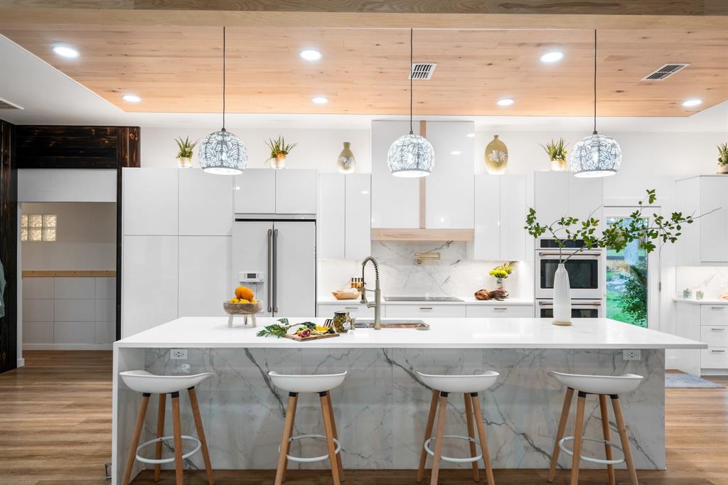 a kitchen with a table chairs and white cabinets