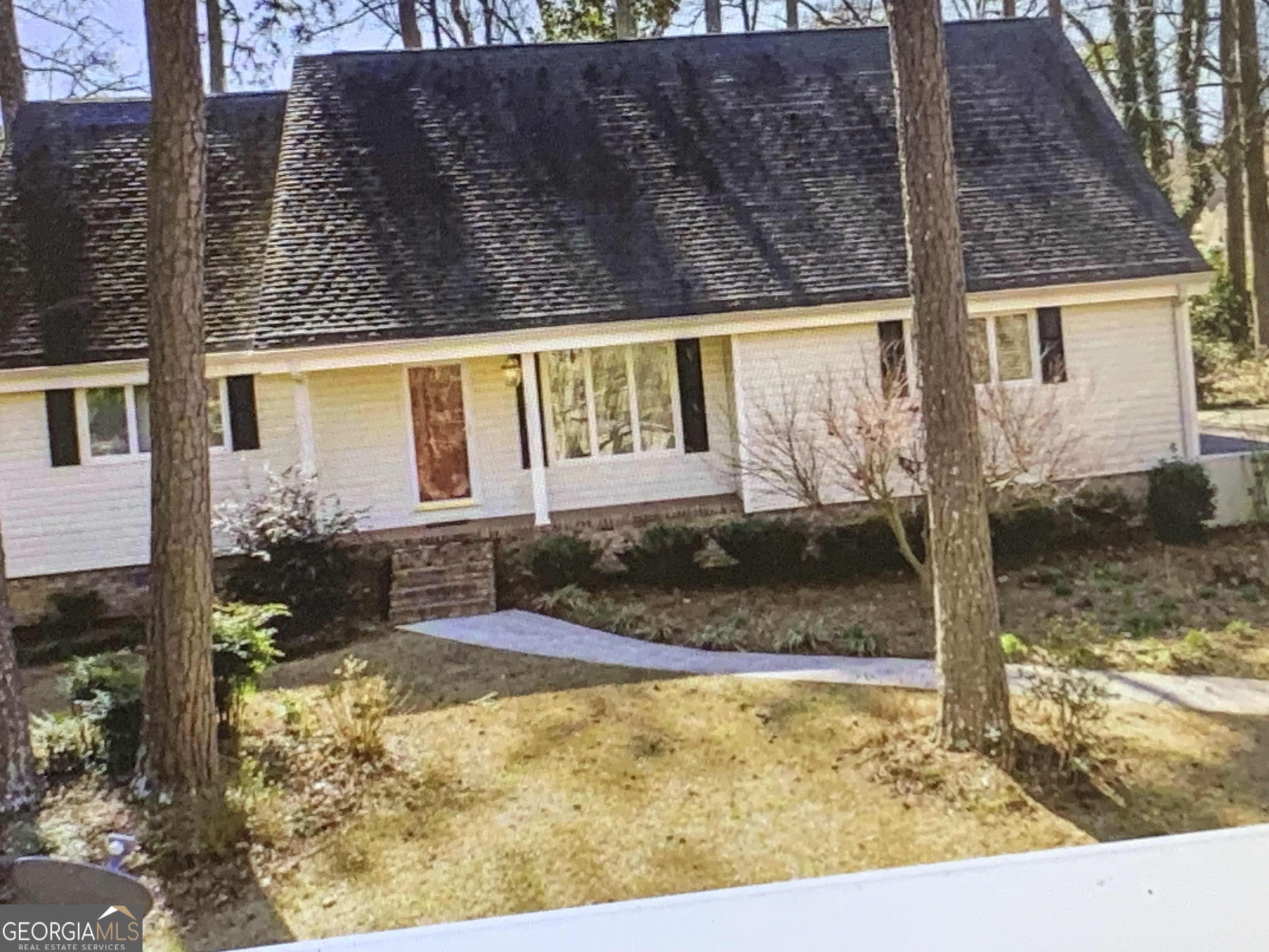 a view of a house with snow on the road