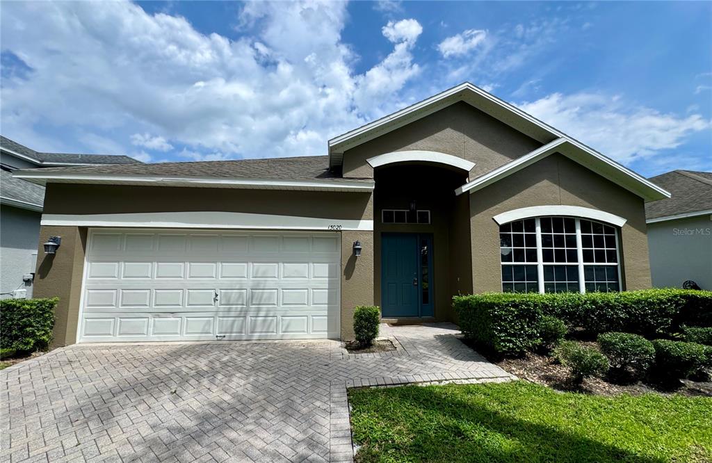 a front view of a house with a yard and garage