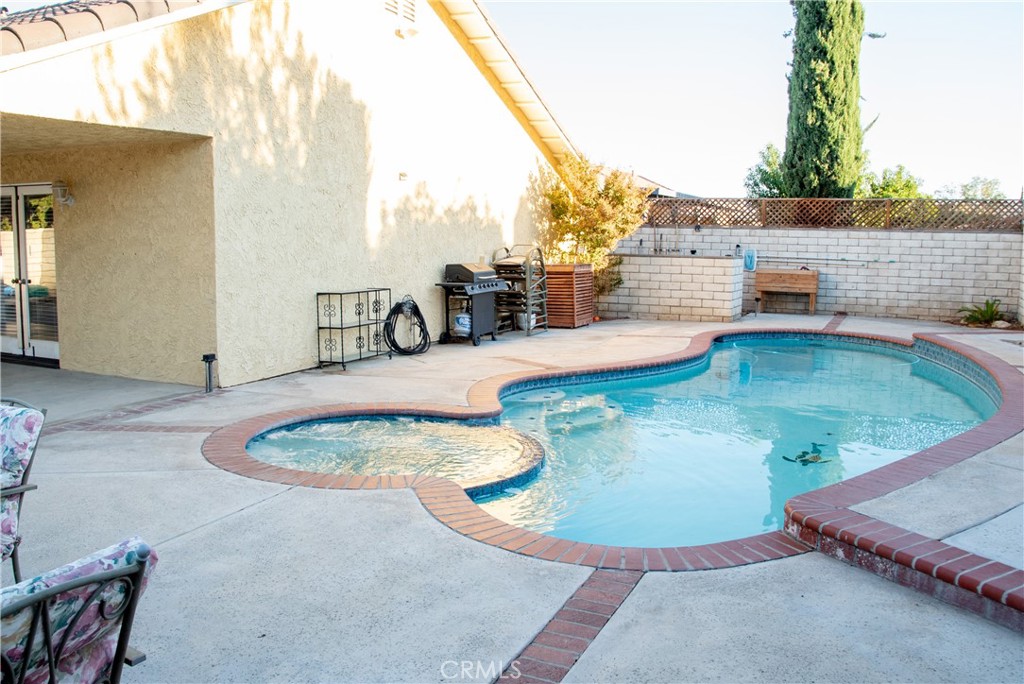 Built in pool and spa completely surrounded by a private block wall.  To the left is the large rear patio.