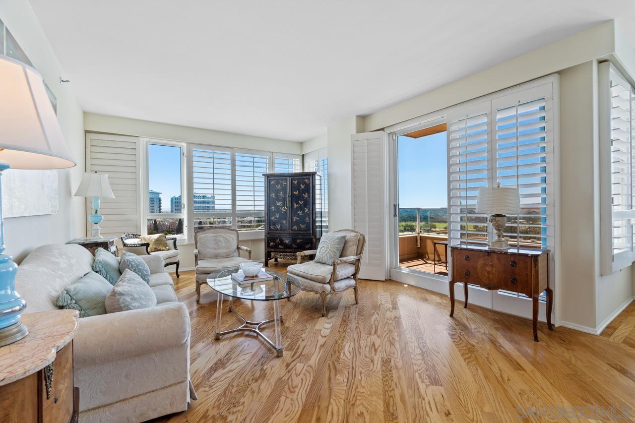 a living room with furniture and floor to ceiling windows