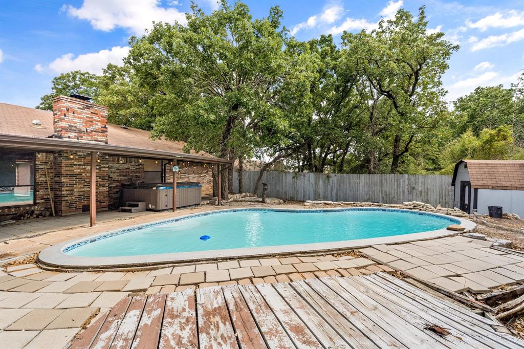 a view of a swimming pool with a patio