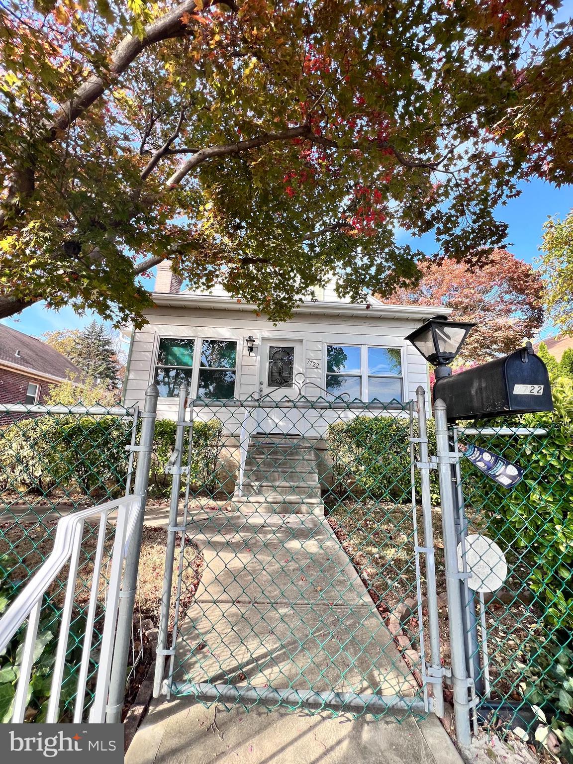 a view of house with a tree in front of it