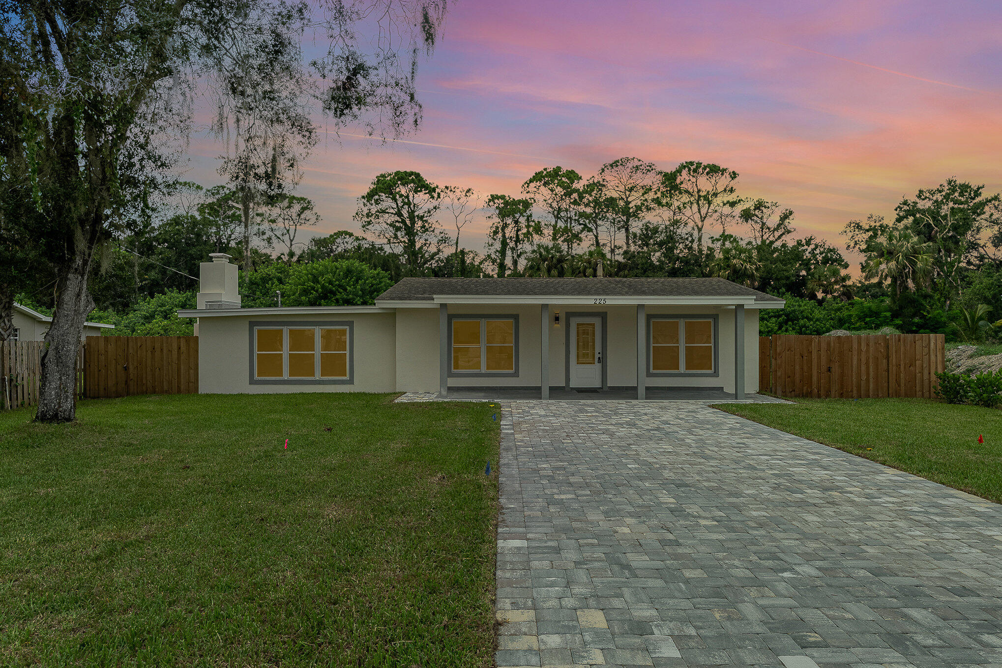 a front view of a house with a garden