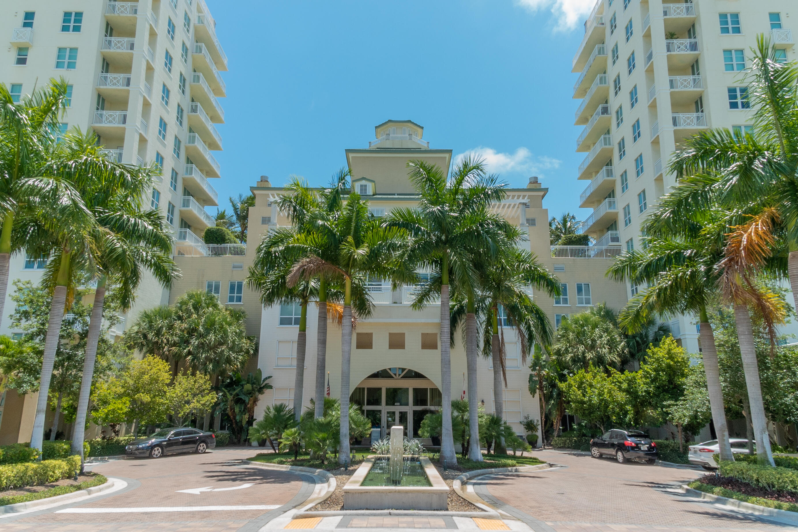 a front view of a multi story building with yard