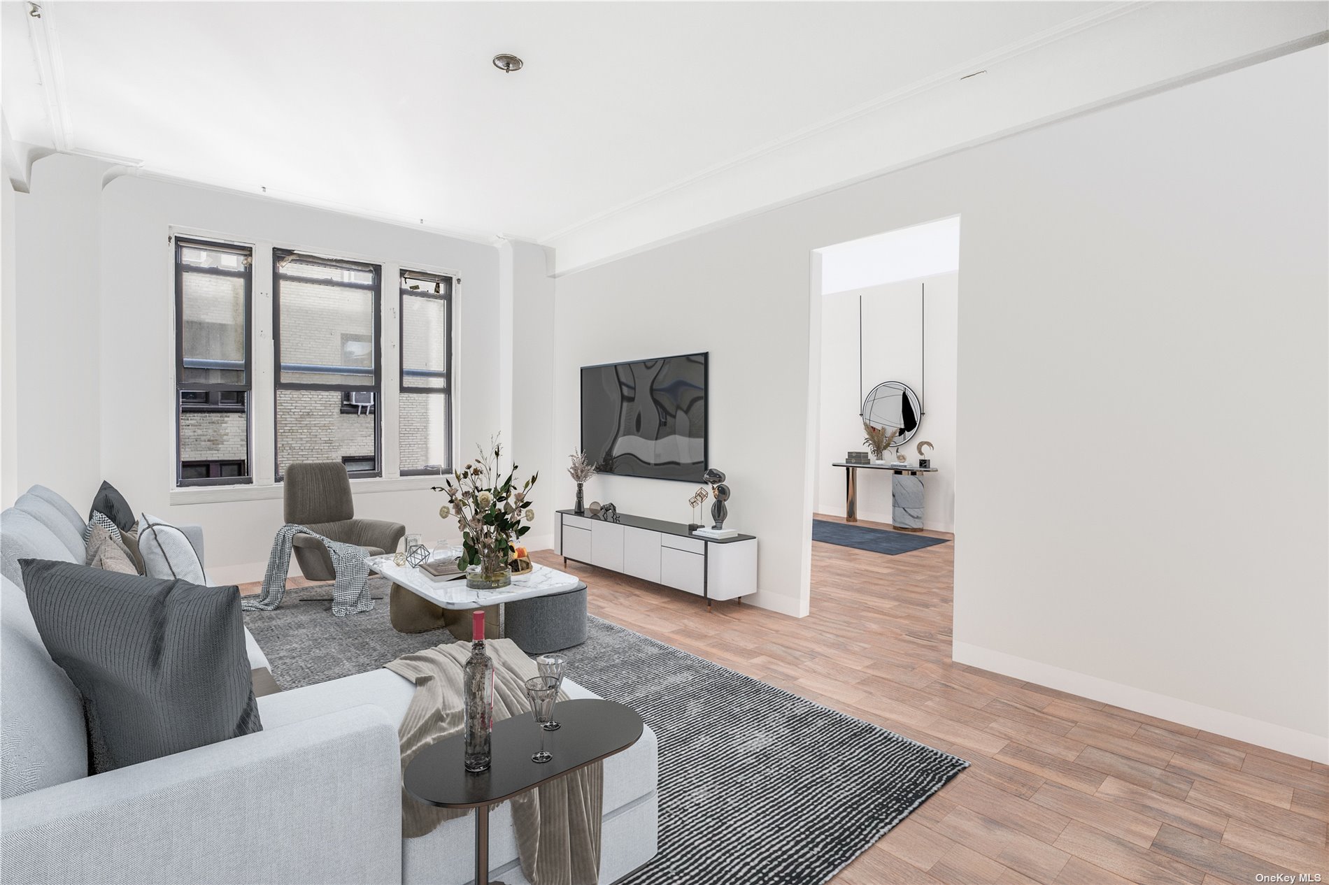 a living room with furniture and wooden floor