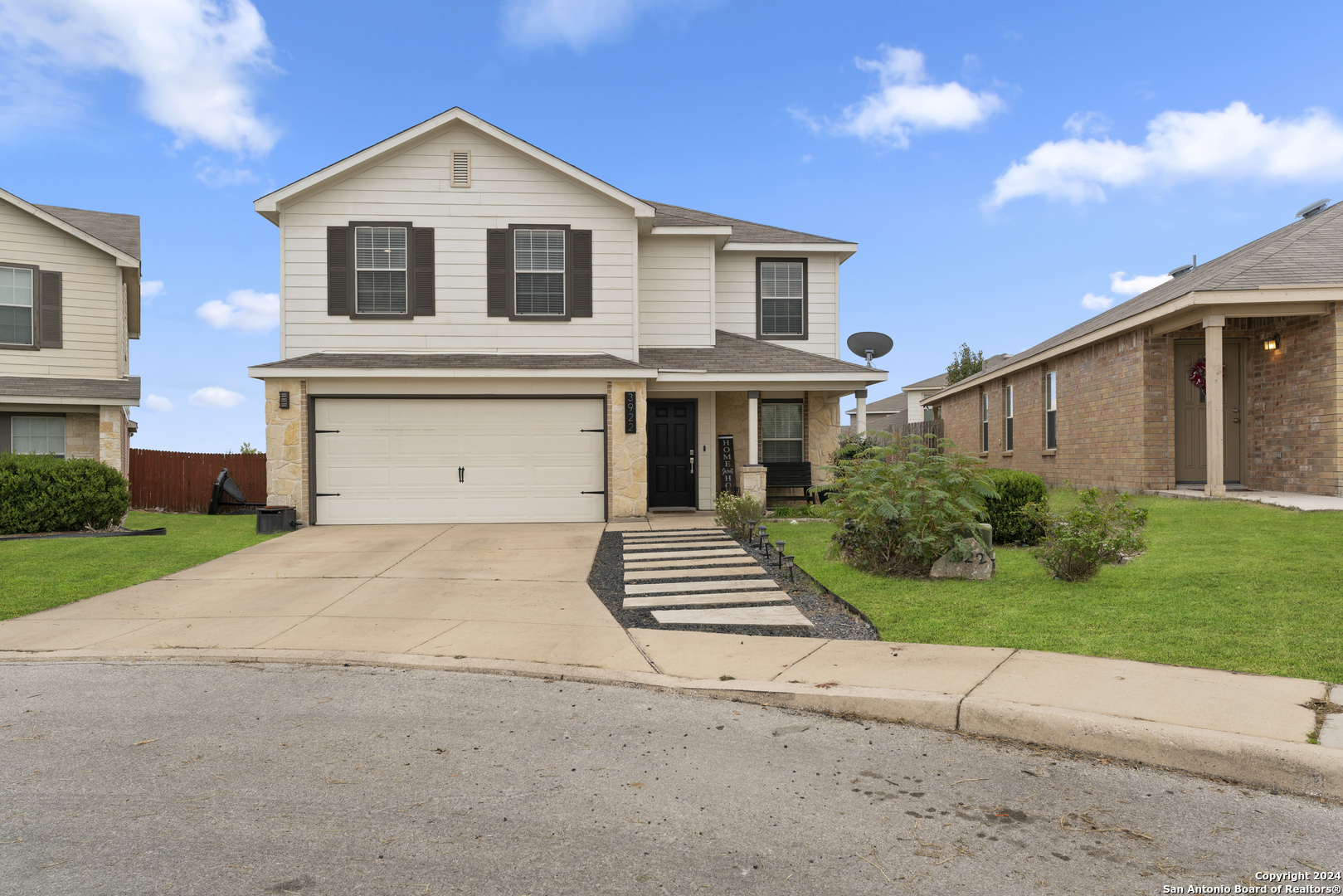 a front view of a house with a yard and garage