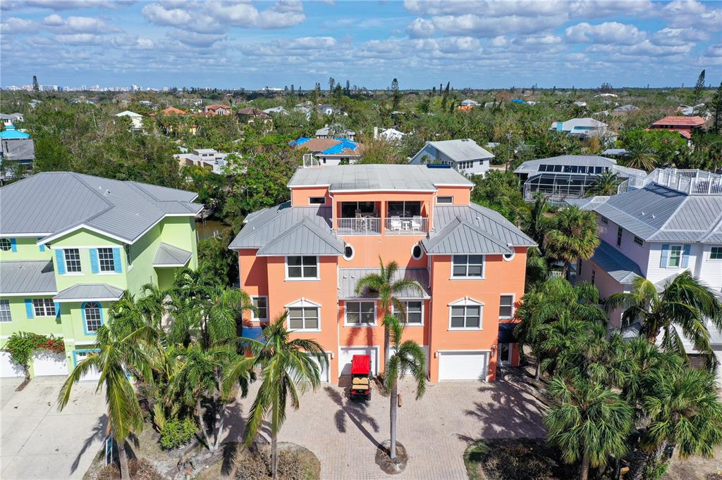 an aerial view of multiple houses with a yard