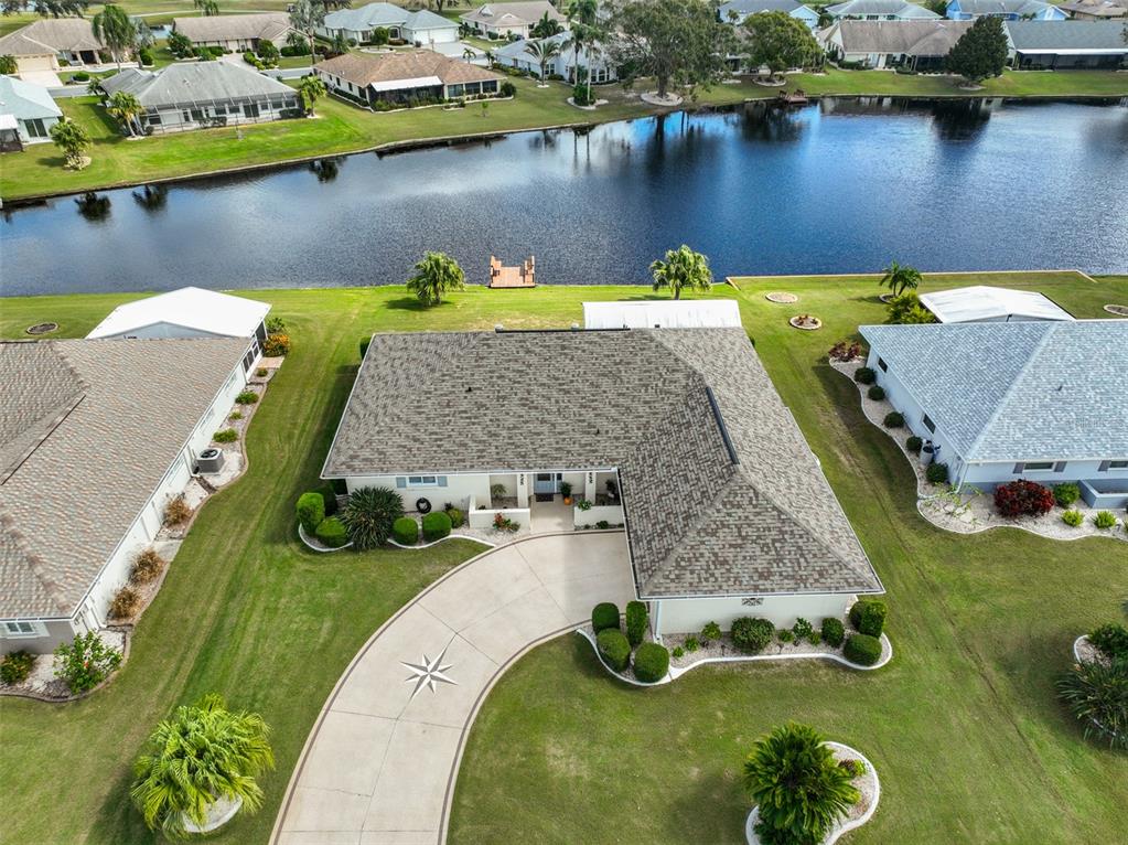 an aerial view of a house with a swimming pool and outdoor seating