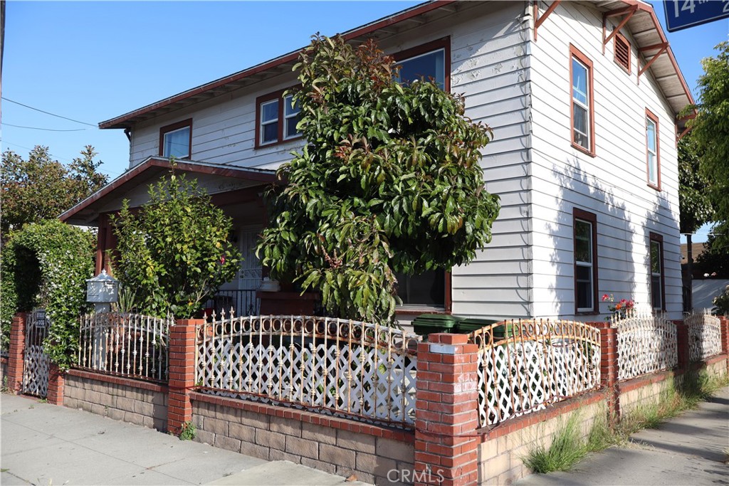 a house view with a fence and trees