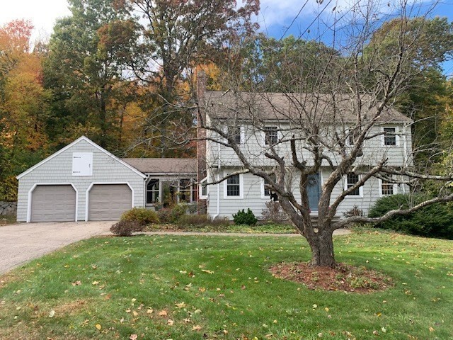 a front view of house with yard and green space