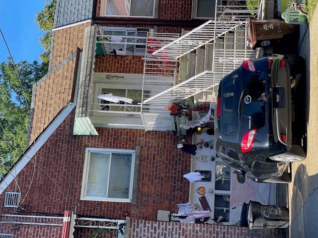 a front view of a house with cars parked