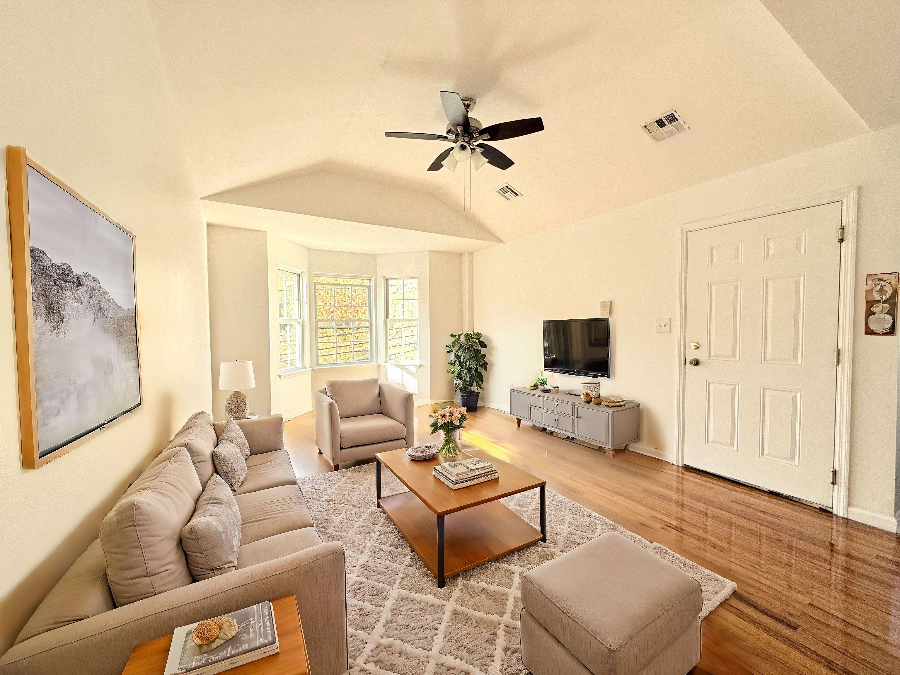 a living room with furniture and a flat screen tv