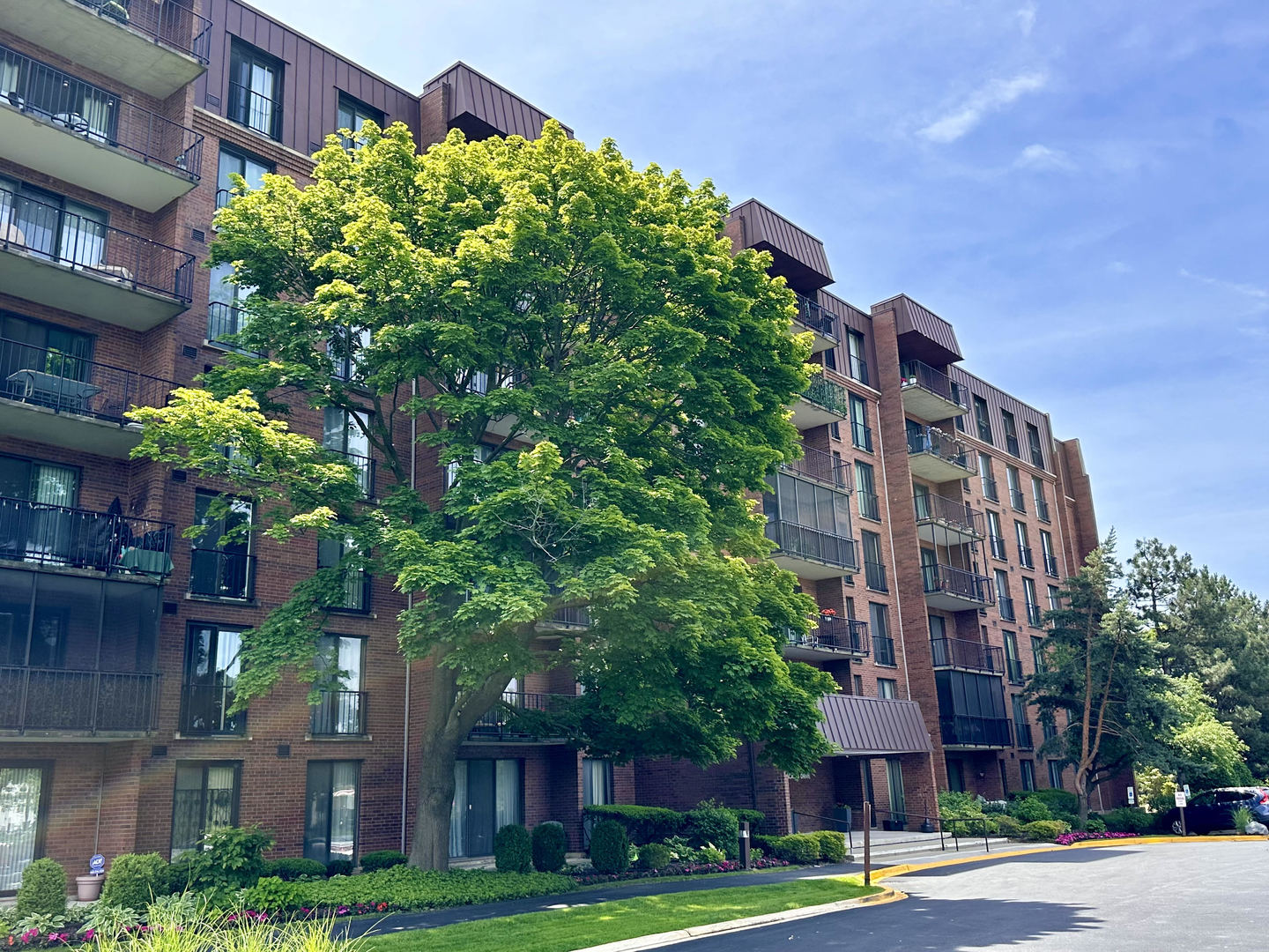 a front view of a multi story building with yard