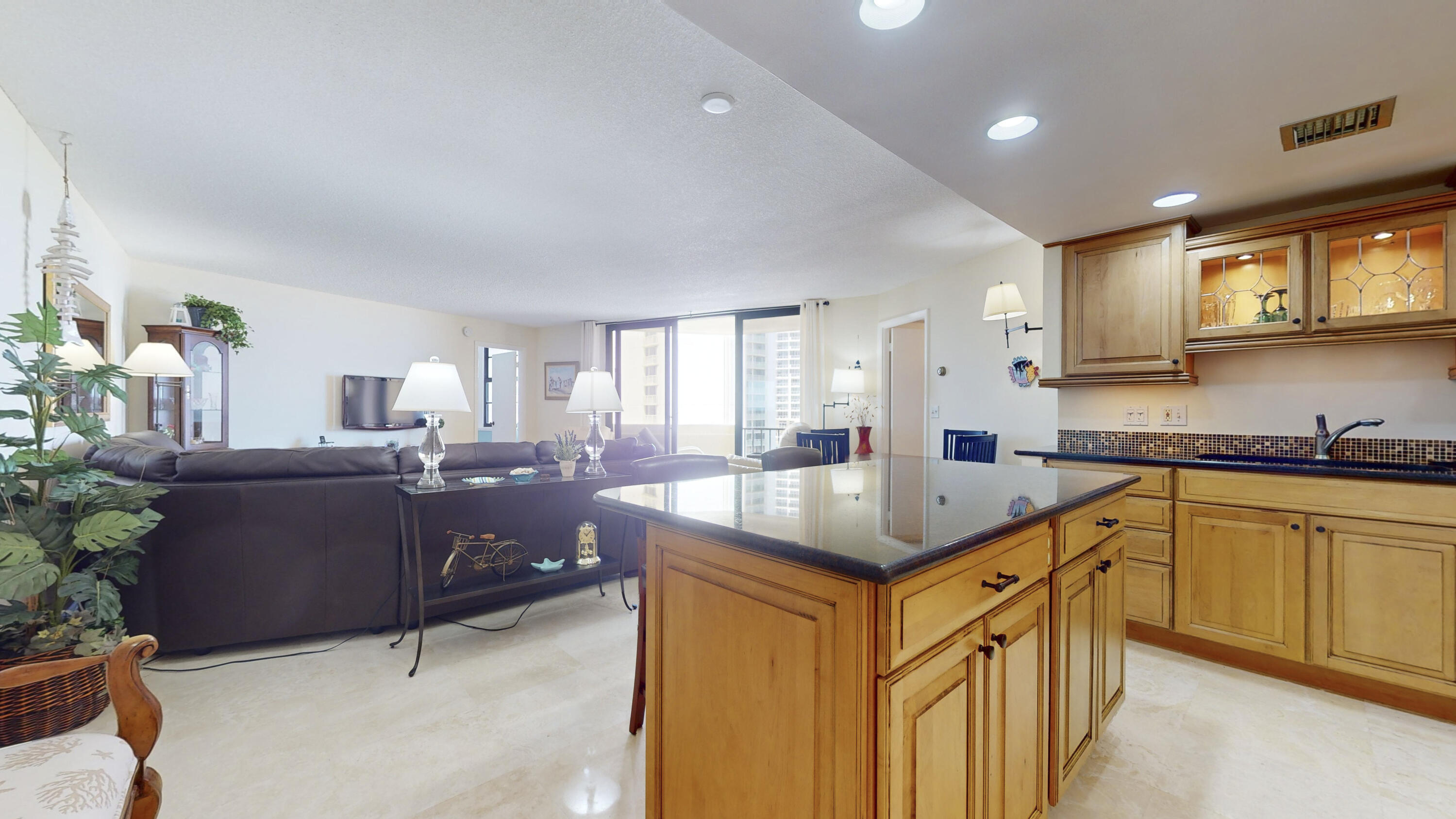 a kitchen with granite countertop a sink stove and cabinets