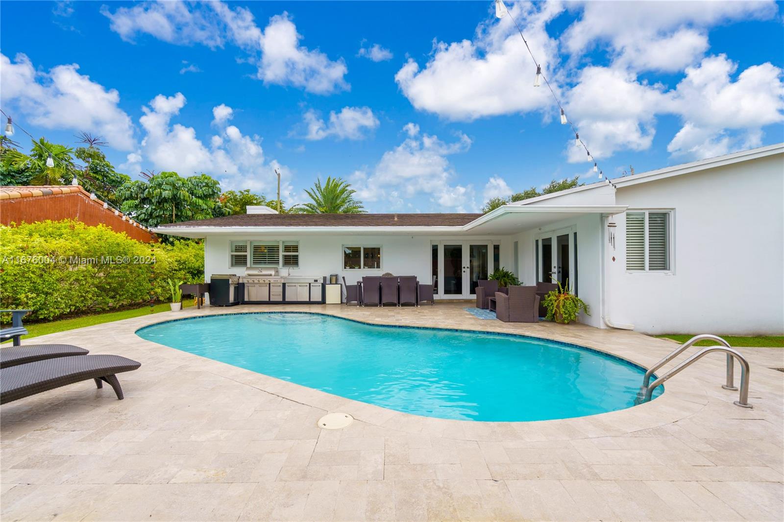 a view of a house with swimming pool and sitting area