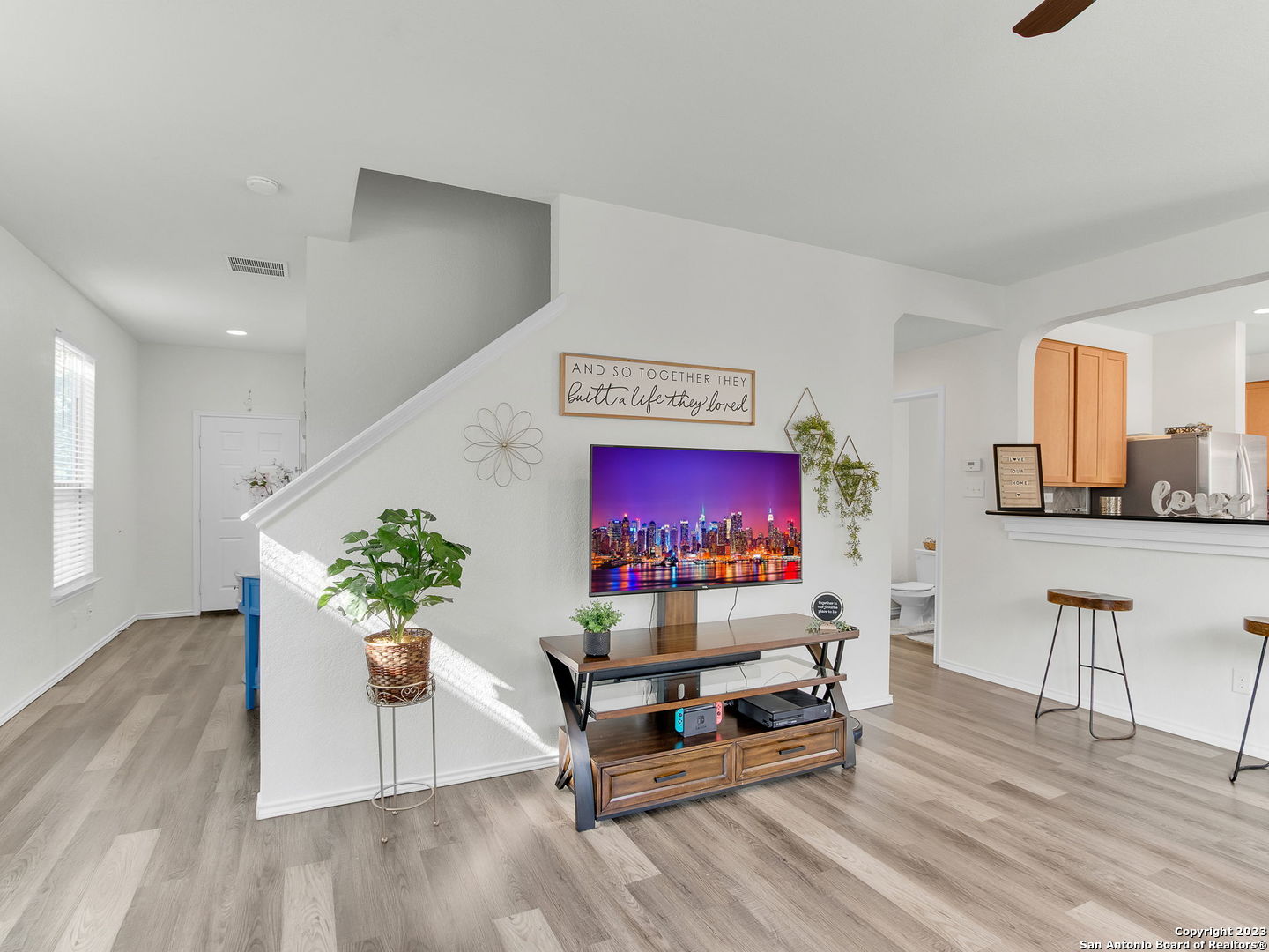 a living room with furniture and a wooden floor