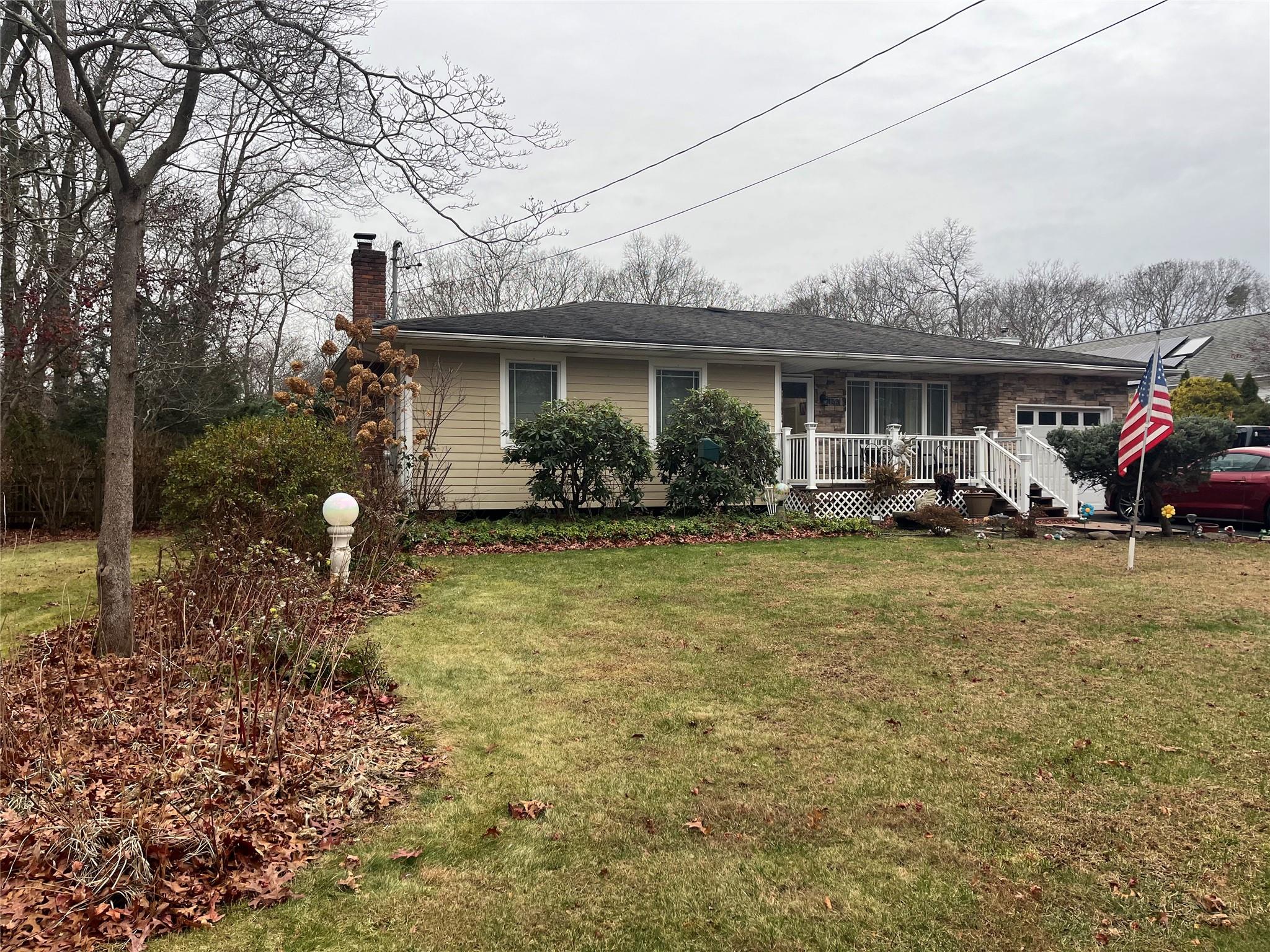 Single story home featuring a front yard and a porch