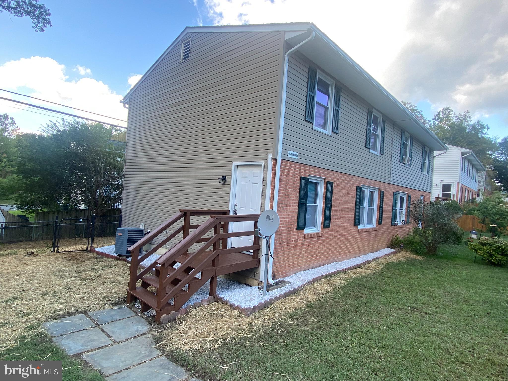 a view of a house with a yard and sitting area