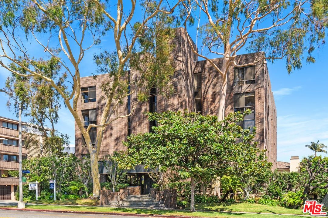 a building view with tall trees