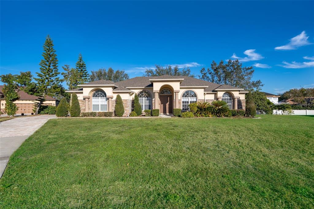 a front view of a house with a garden