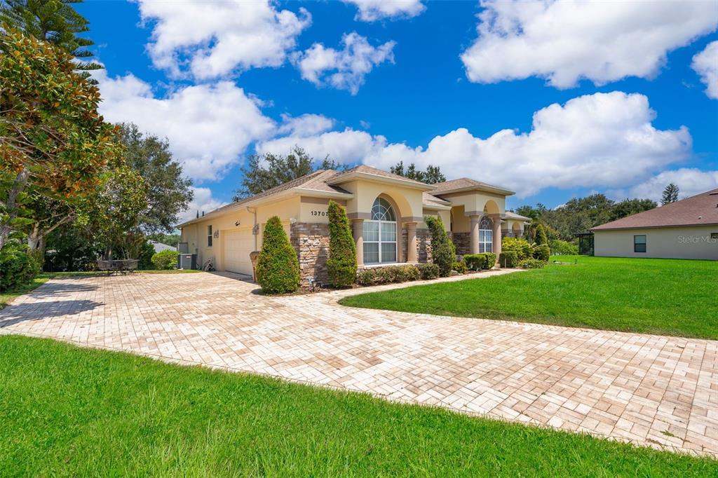 3 car garage and brick pavers driveway