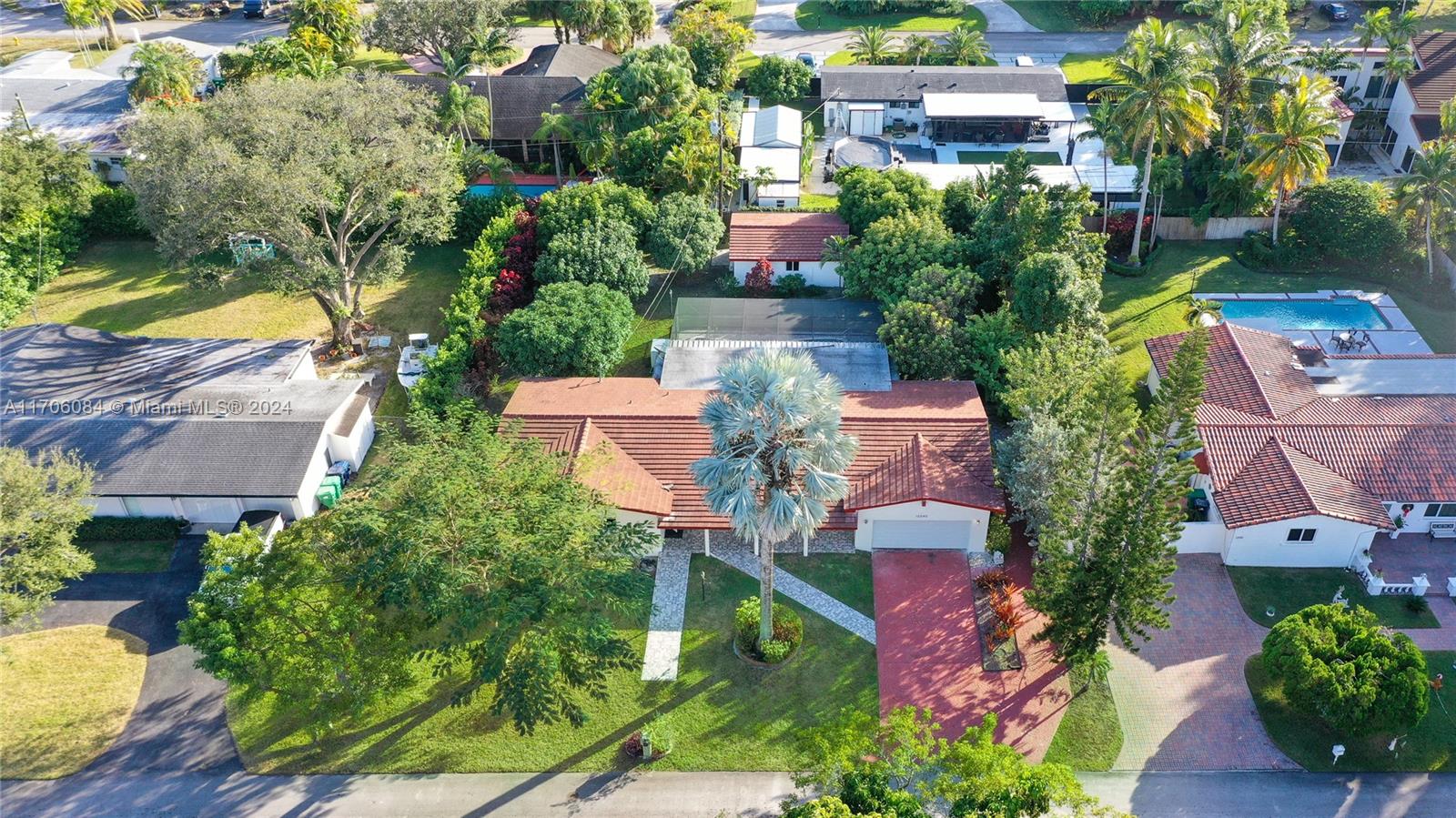 an aerial view of a house with yard swimming pool and outdoor seating