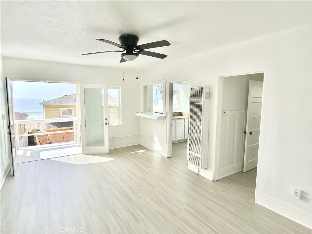 a view of a kitchen with wooden floor a sink and a window