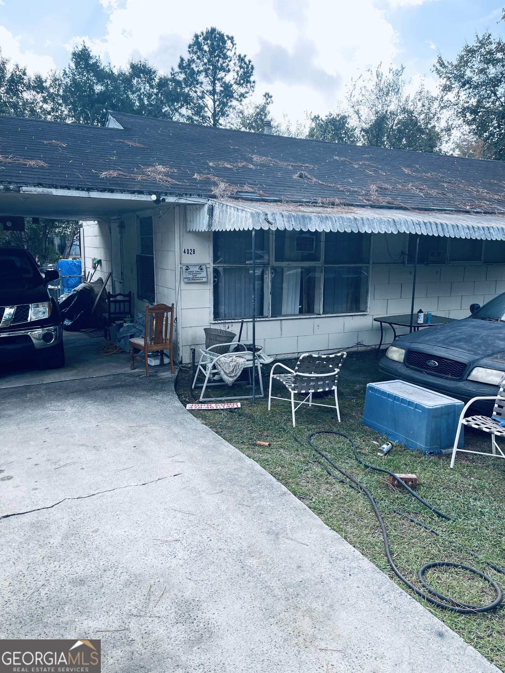 a view of a house with a yard and sitting area