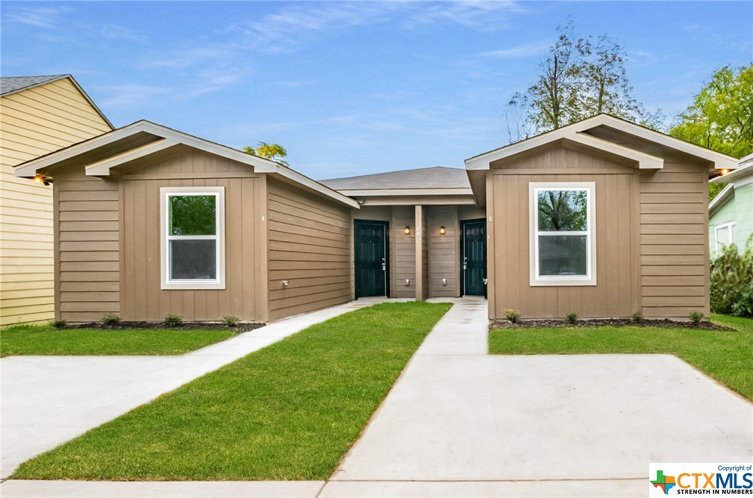 a front view of a house with a yard