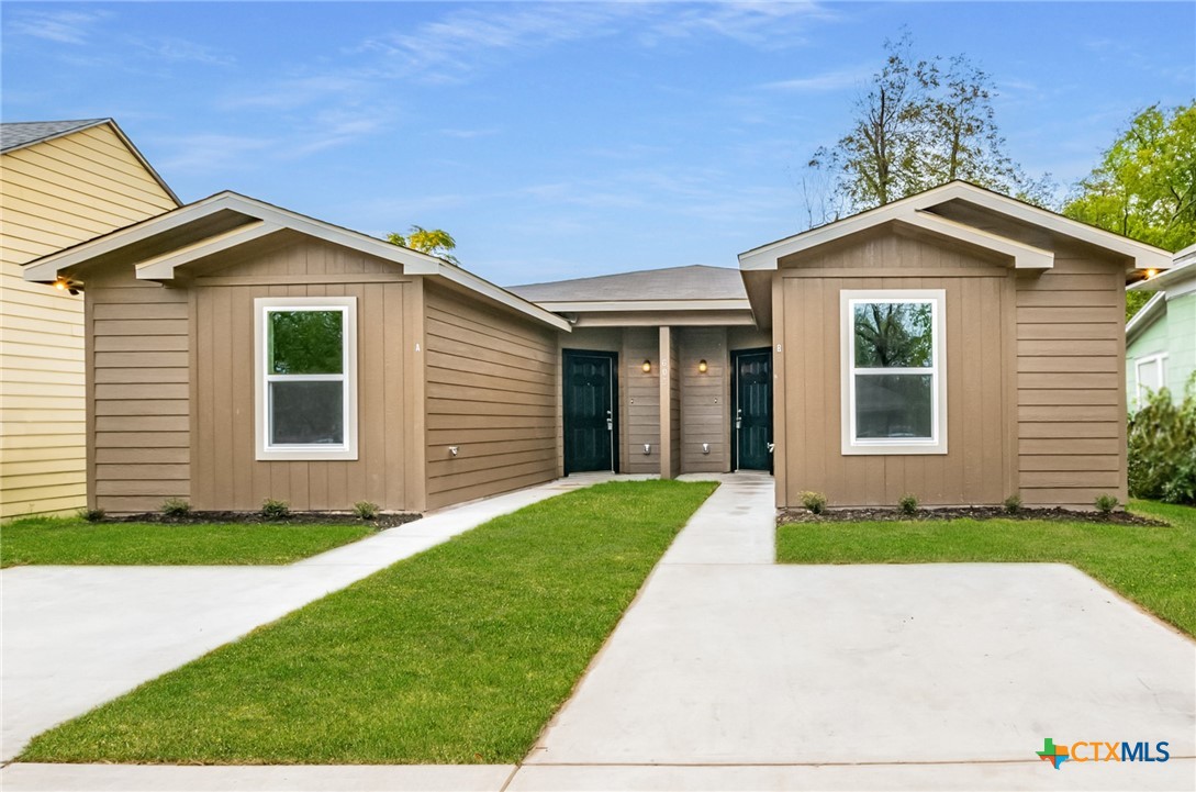 a front view of a house with a yard