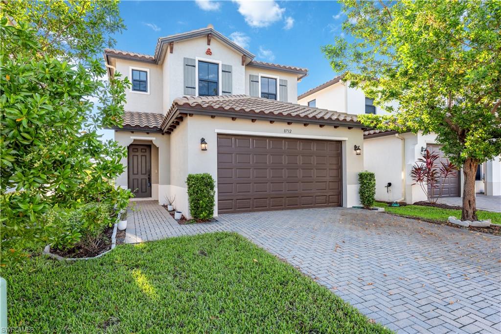 Mediterranean / spanish home with a front lawn