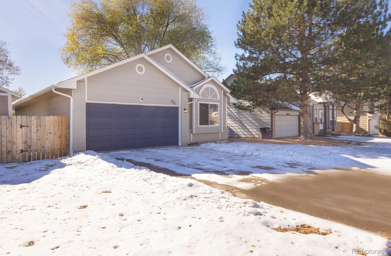 a view of a house with a yard covered in snow