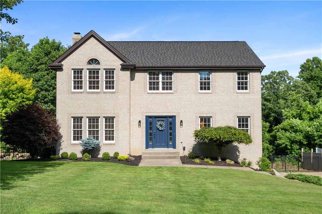 a front view of a house with a garden and yard