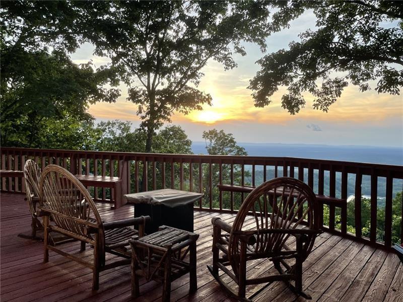 a view of a wooden chairs on the deck