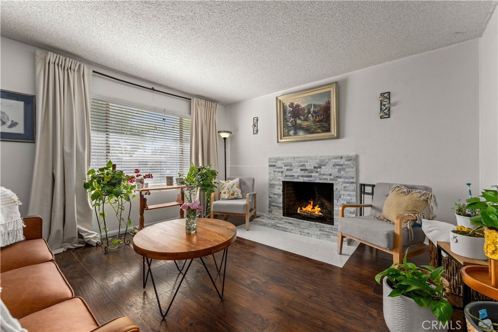 a living room with furniture potted plant and a fireplace