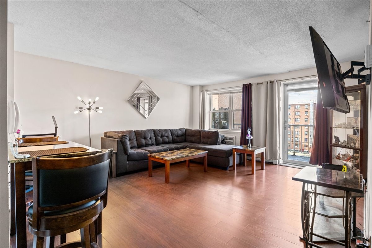 a living room with furniture a fireplace and large windows