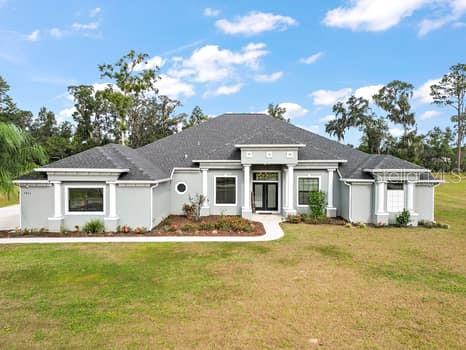 a front view of a house with a garden