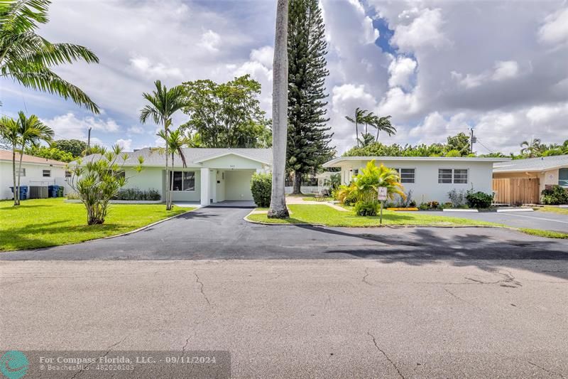 Front of single family home and triplex with view of beautiful trees.  Nice curb appeal.