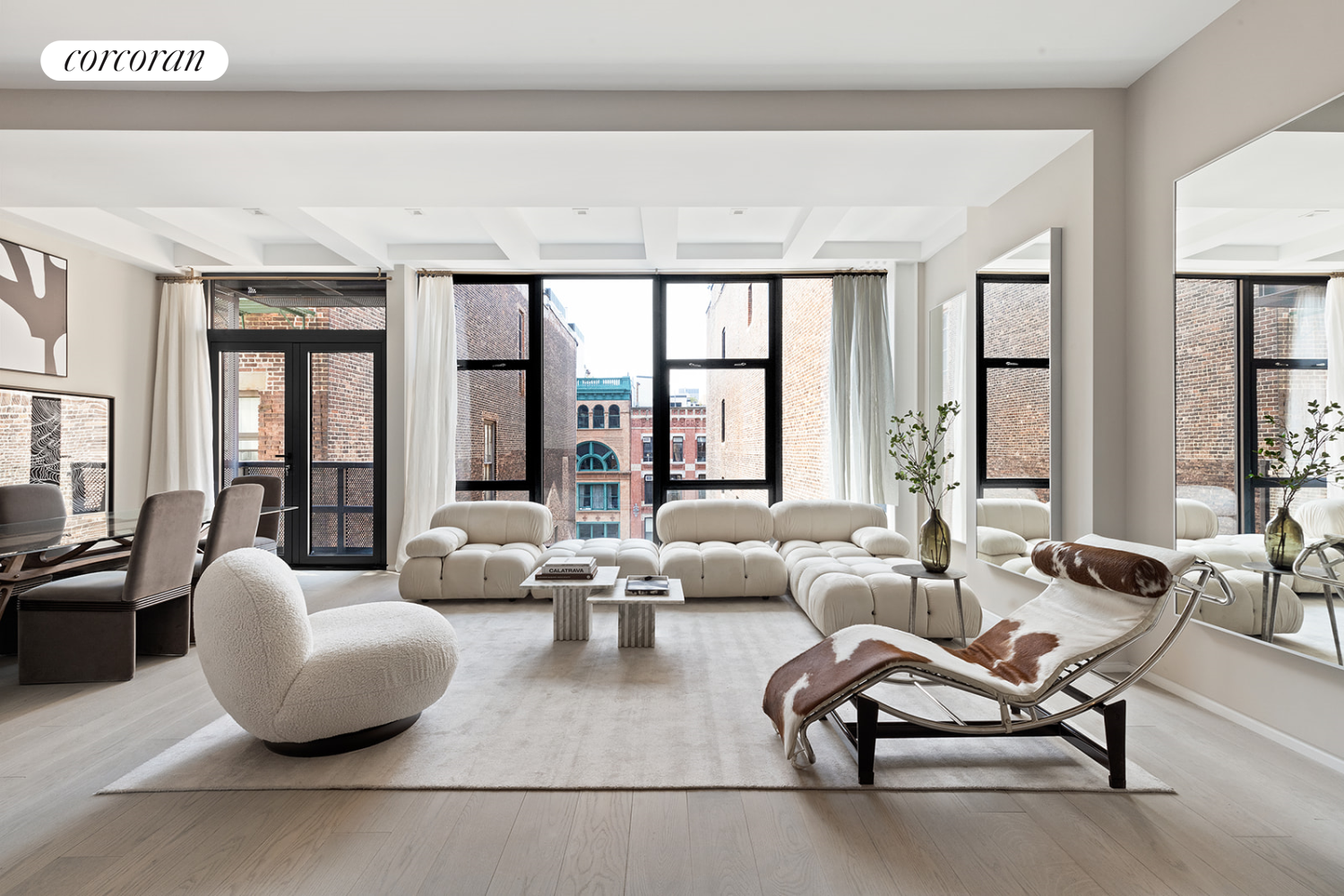 a living room with furniture and large windows