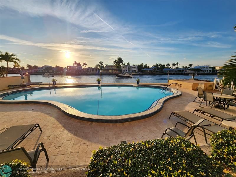 a view of a swimming pool with outdoor seating space