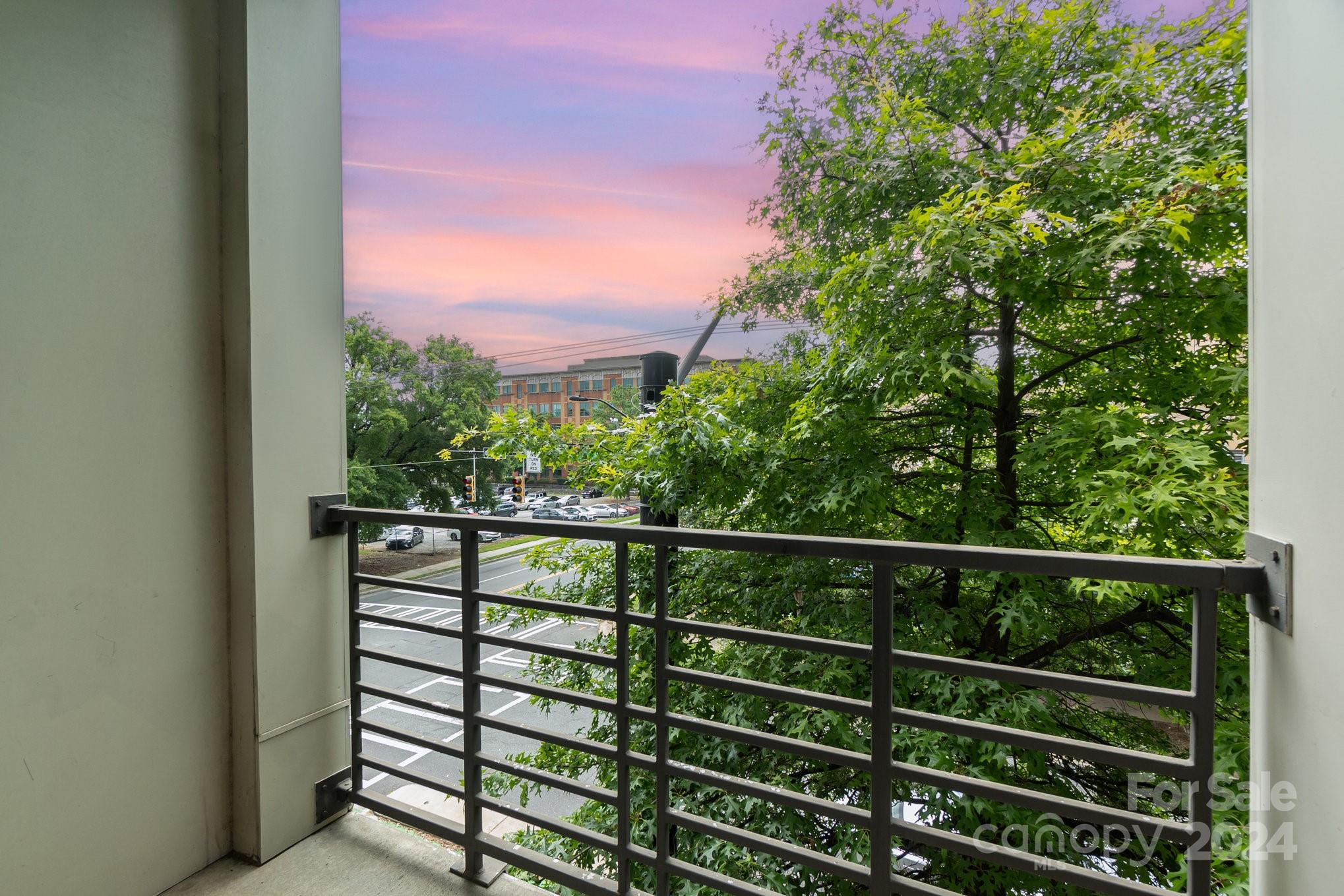 a view of a balcony with a green space