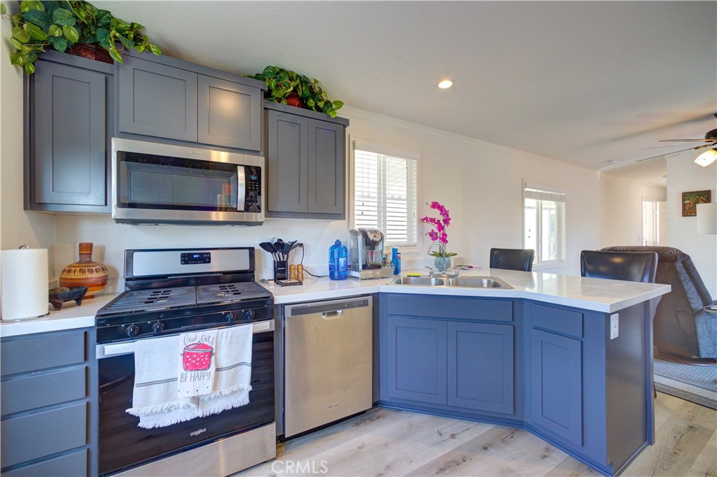 a kitchen with a sink stove and microwave