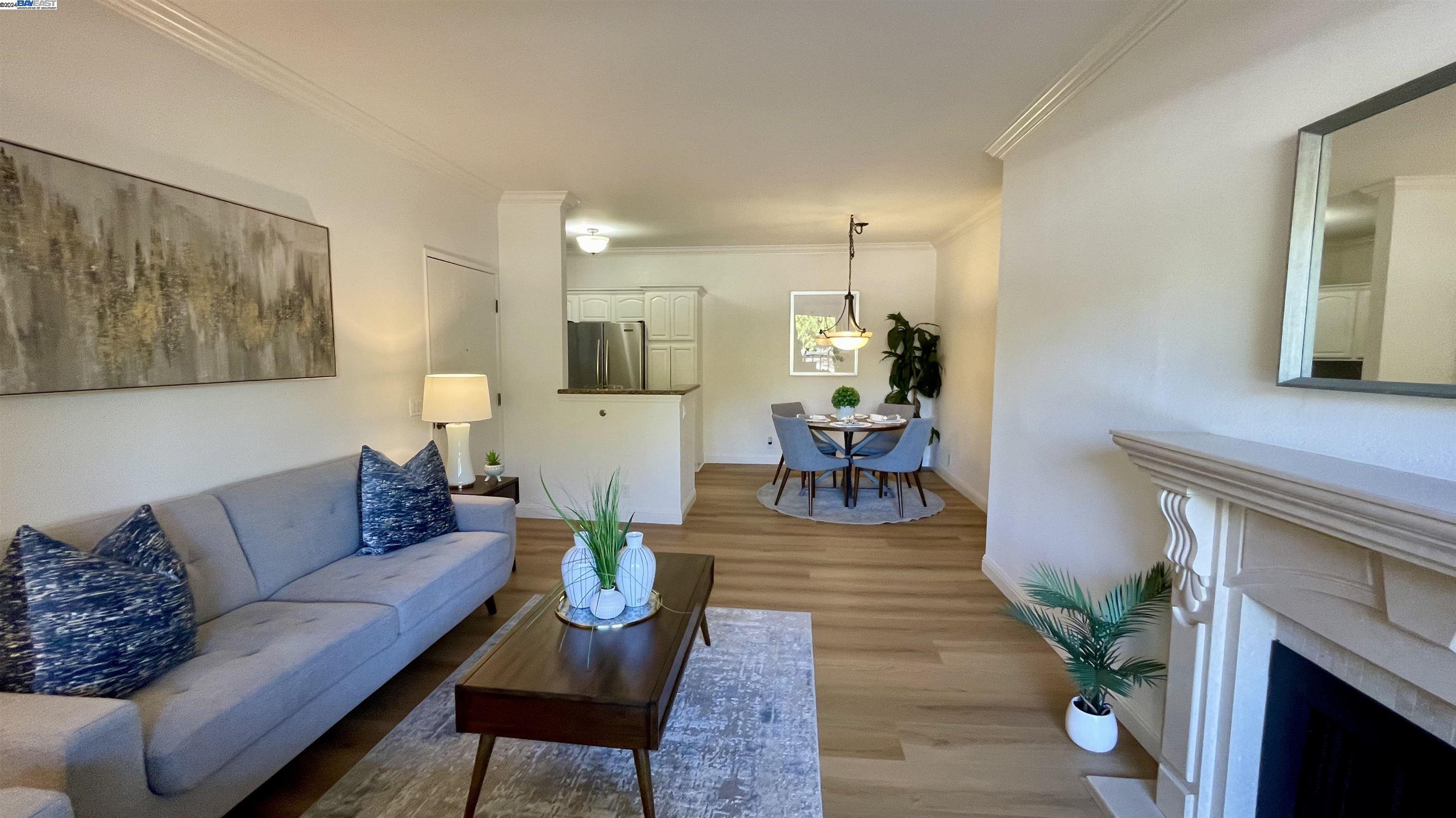 a living room with furniture a fireplace and a window