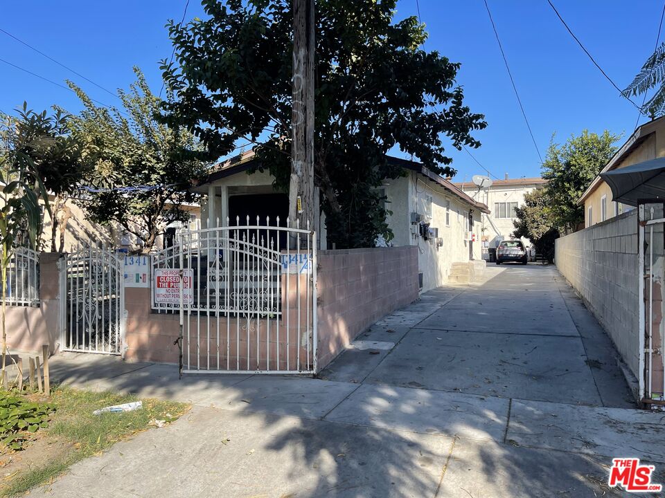 a view of a house with a tree in front of it